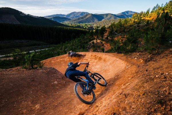 Bike riders with mountainscape background at Mystic Bike Park
