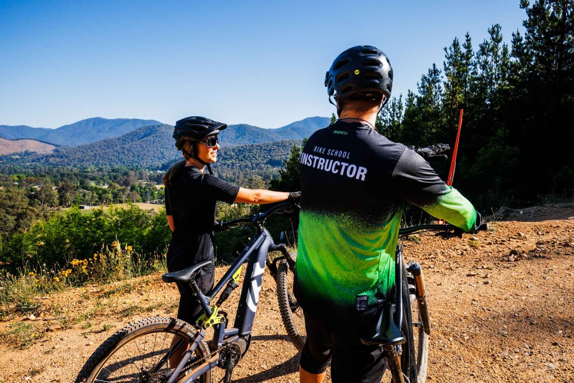 Two riders looking at mountain views at Mystic Bike park in Bright
