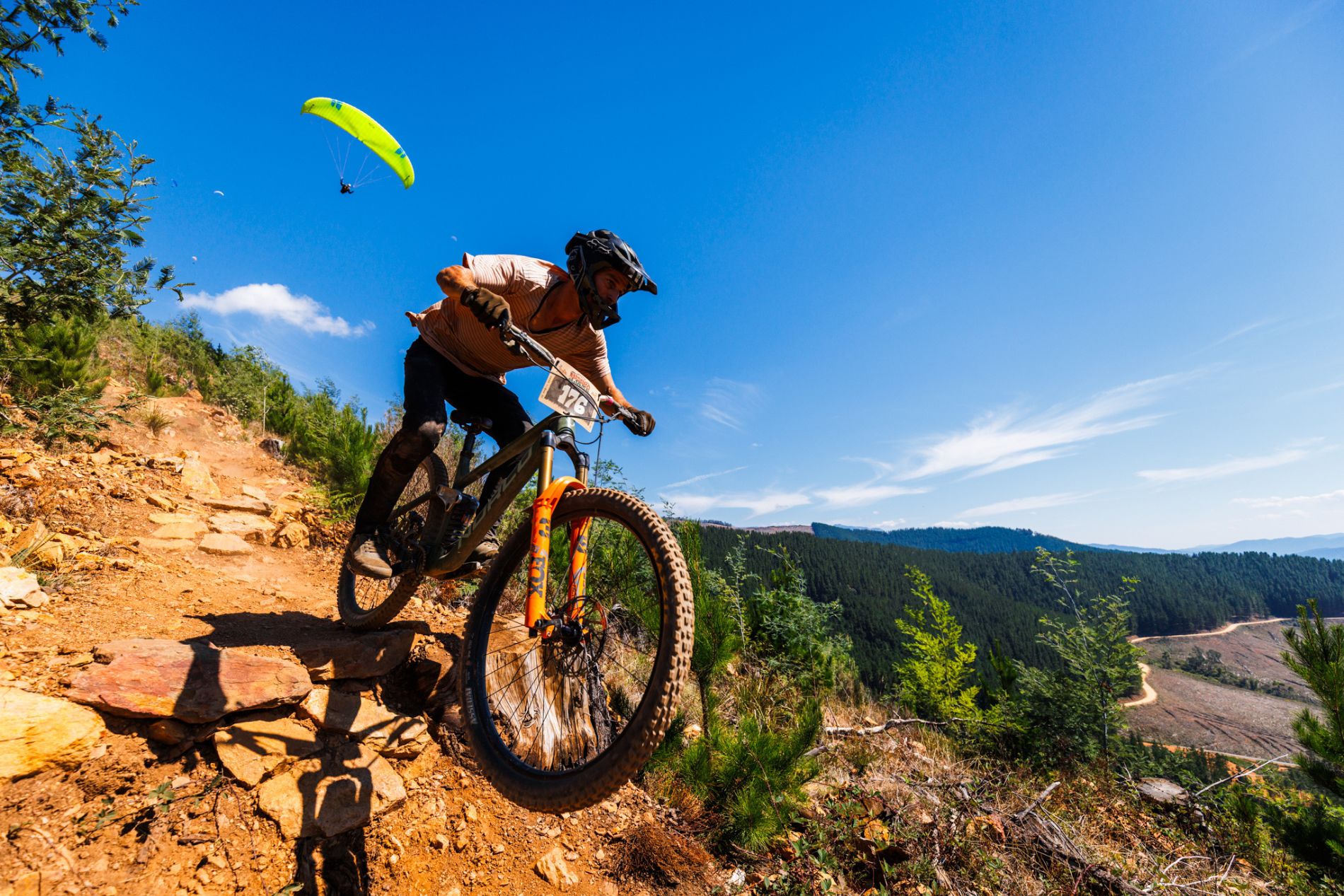 Mountain bikers with paraglider at Mystic Bike Park in Bright Victoria