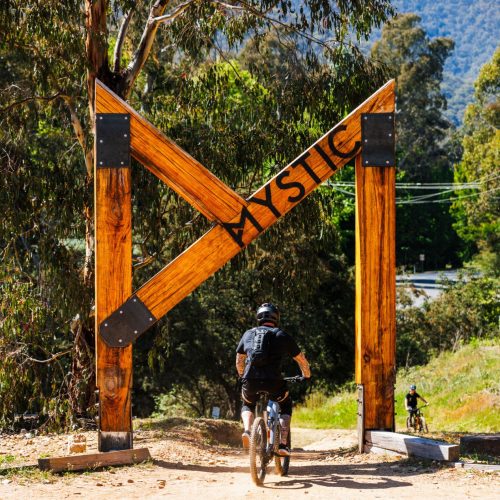 Bike riders on mountain bike under the Big M for Mystic Bike Park