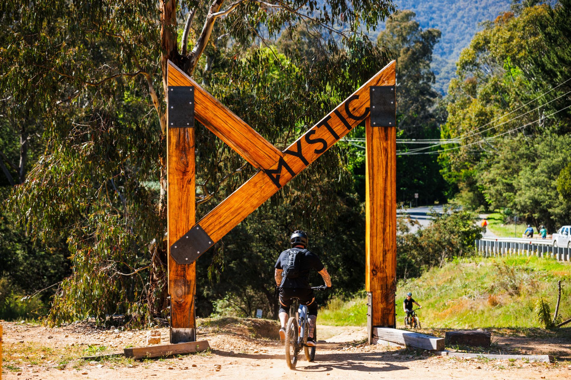 Bike riders on mountain bike under the Big M for Mystic Bike Park