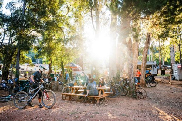 Summer Sesh - Bar & live music open to riders and walk ins Gathering of people at a Bike Park for a special event at Mystic Bike Park surrounded by trees